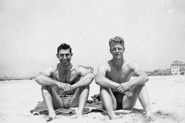 Vintage friends swimming on beach.