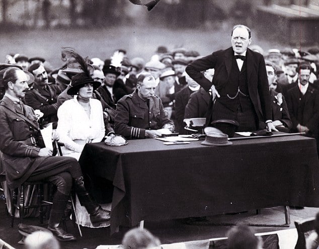 Winston Churchill standing speaking at meeting. 