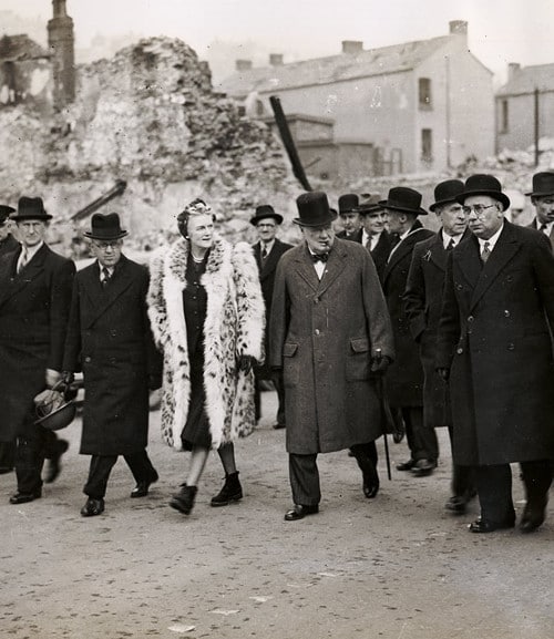 winston and clementine churchill touring war ruin with group of men