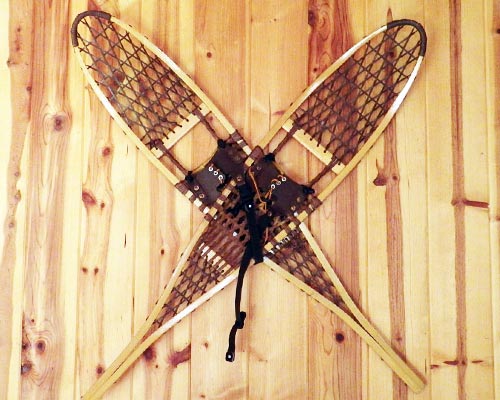 vintage wooden snowshoes hanging on wall