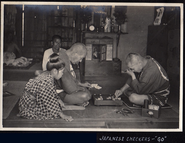 Vintage japanese men playing checkers.