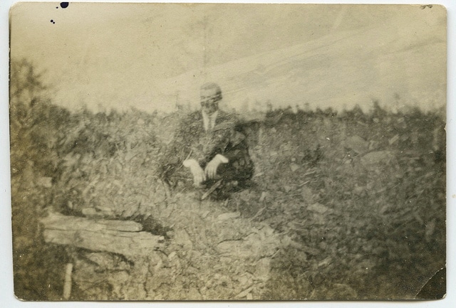 Vintage man sitting in field hazy resolution.