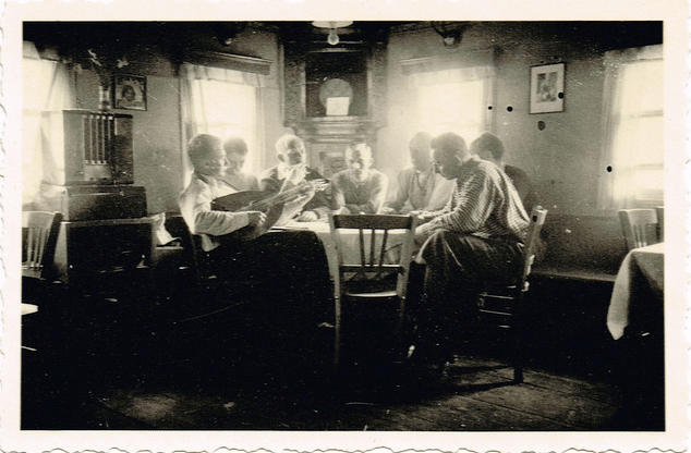 Vintage men sitting at dinner table talking. 