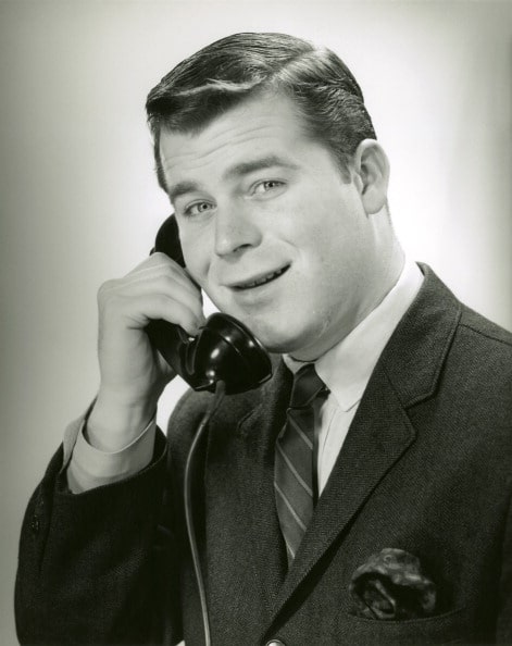 Vintage man on telephone with smiling face.