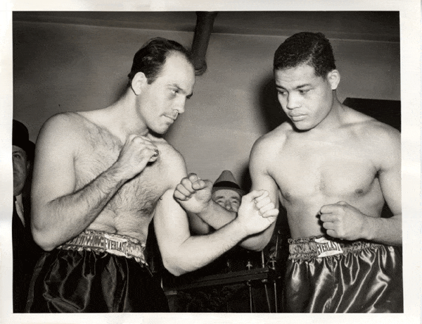 Johnny Paychek poses with Joe Louis before their fight for the heavyweight title.