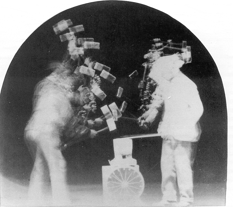 Two men using hammer for multiple exposures. 