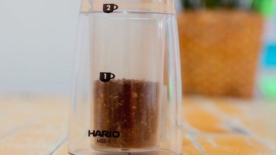 Step 4: Grind just enough coffee so that you reach the first cup symbol on the grinder. (Most modern hand grinders will have some sort of marking.)