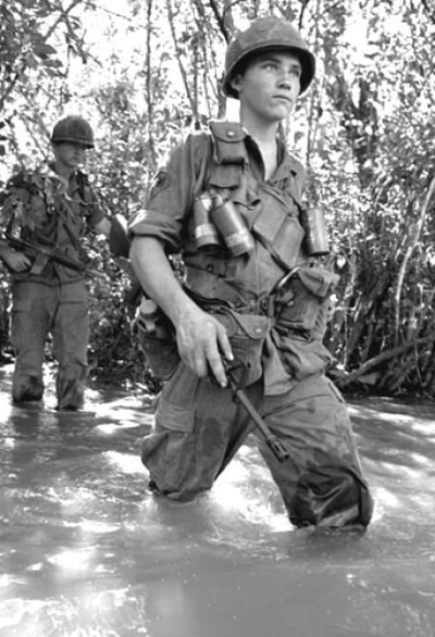 soldier in vietnam wading through river