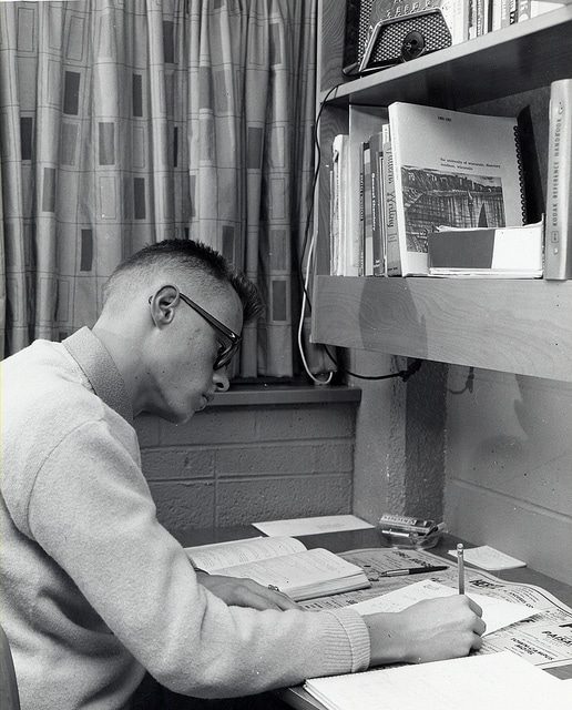 Vintage 1950s Young man college door room studying.