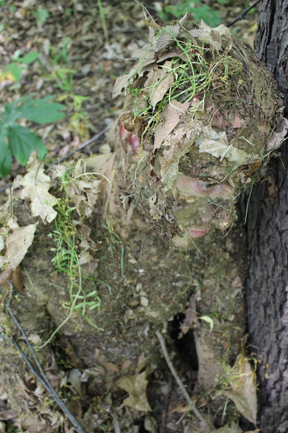 Men camouflage with mud and laves.