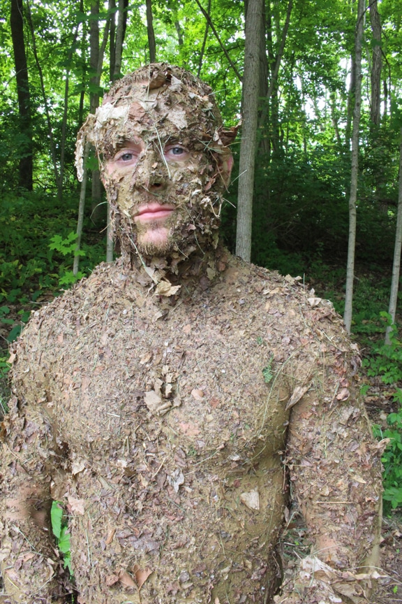 Men covered in stewart forest debris natural camouflage.