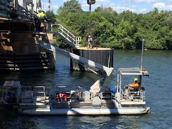 On a pontoon lift while inspecting and repairing lights used for marine navigation around a railroad bridge. Although the the pontoon lift is not extremely common, it's within the purview of my daily duties.