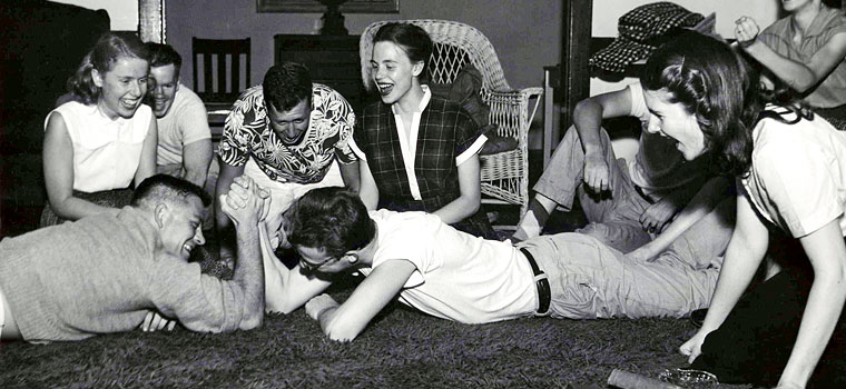 Vintage guys arm wrestling co-ed party 1940s 1950s.