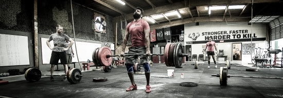 Men Exercise with heavy weight in well Equipped gym.