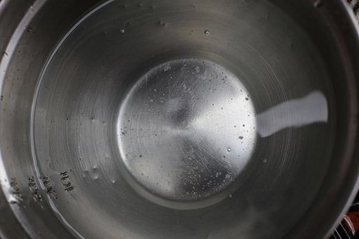 clean water in a silver metal bucket