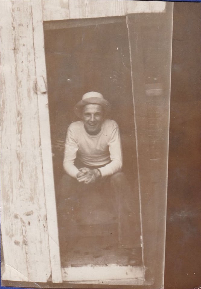 Vintage Man in outhouse.