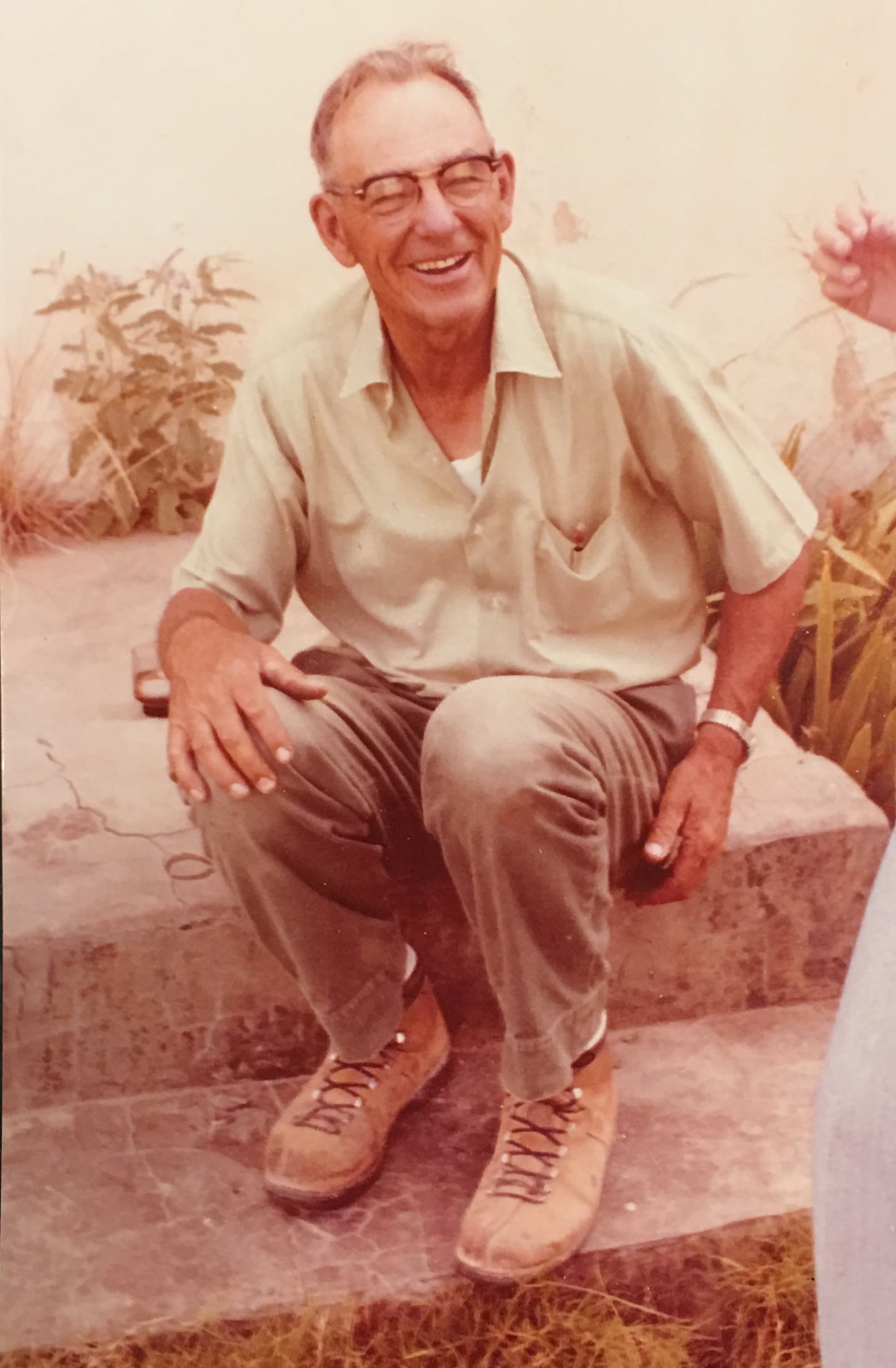 Vintage William M. sitting on stairs.