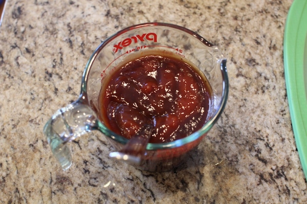 Ketchup with spoon in a cup.