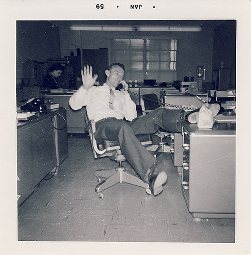 Vintage man calling on phone at office.