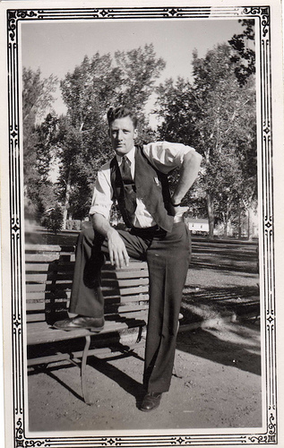 Vintage man giving pose at desk.