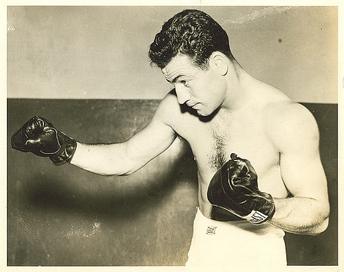 Vintage man giving pose in boxing punch.