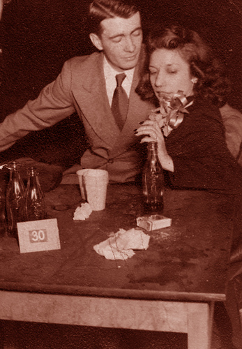 Vintage couple sitting at desk.