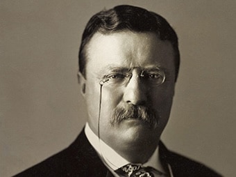 Portrait of a mustachioed man in a suit and pince-nez glasses, embodying lessons in manliness from the childhood of Theodore Roosevelt.