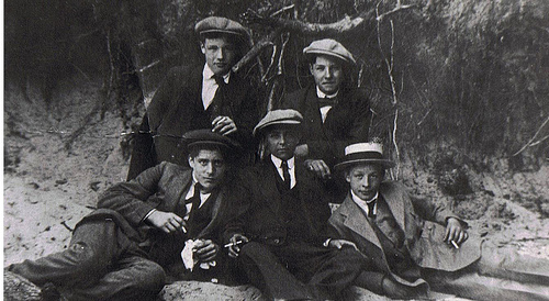 Vintage group of young men wearing flat cap.