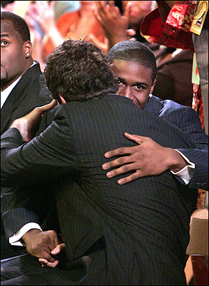 Two men embracing in a warm hug.