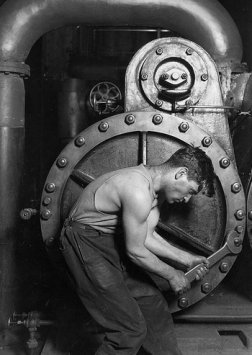 An old black and white photo capturing the industrious character of a man working on a steam engine, leading a virtuous life.