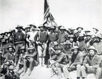 Theodore Roosevelt standing with rough riders.