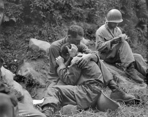 Soldiers crying friends holding each other in vietnam 1960s.