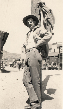 Vintage man standing at telephone pole.