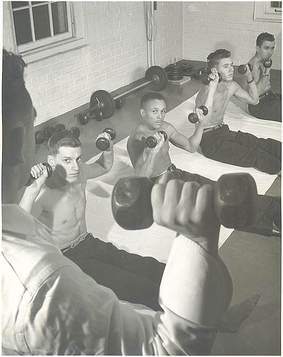 A man holding a dumbbell.