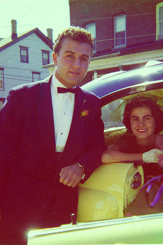 A man and woman in tuxedos having discussions about personal finance before getting hitched.