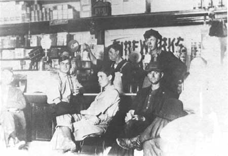 Vintage men sitting at soda fountain.