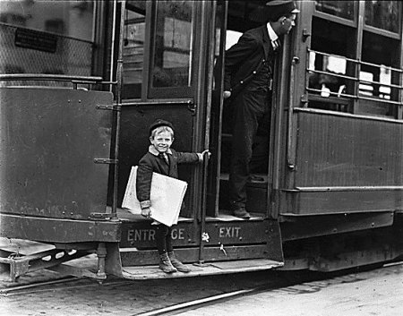 Vintage child standing on train stack for going to work.