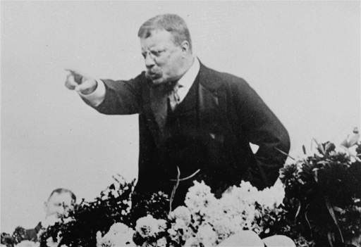 Teddy Roosevelt giving speech with pointing finger.