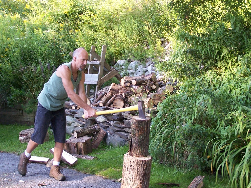 Uncle Buzz is getting in shape while chopping wood with an ax during his workout.