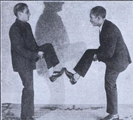 Vintage men foot boxing early. 