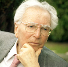 Viktor Frankl, a man wearing glasses and a tie with an aura of manliness.