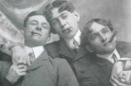 Vintage men friends smoking cigars portrait early 1900s.