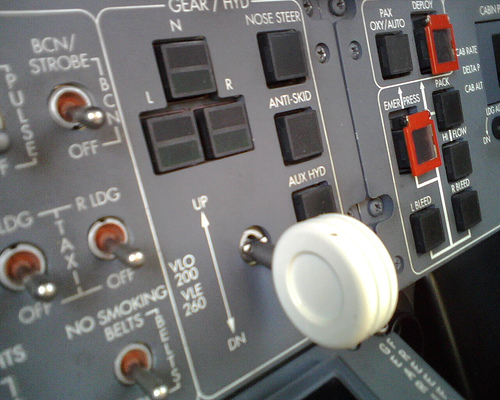 Landing gear controls airplane cockpit close up photo.