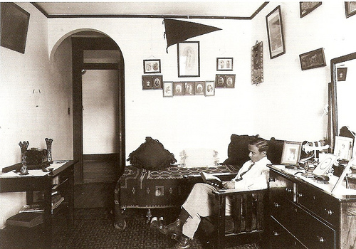 Vintage man reading in dorm room.