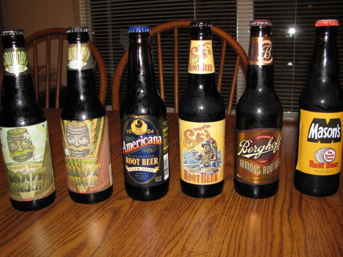 A group of soda bottles, including some of the best root beer options, arranged neatly on a table for a comprehensive review.