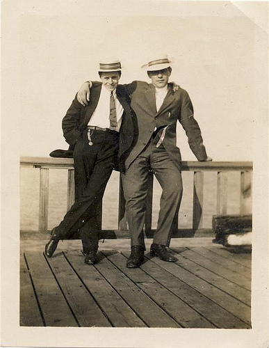 Two men keeping a pose on a wooden deck.