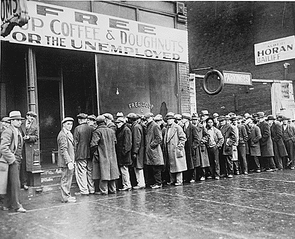 A group of people, including a man dealing with unemployment, standing in line in front of a store.