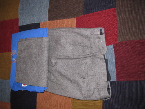 Folding shirt slacks for a suitcase.