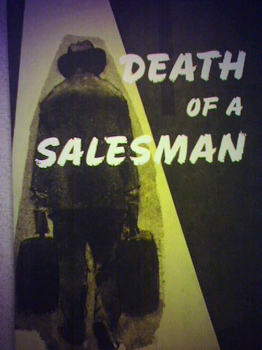 Death of a salesman poster and Willy Loman a play man holding bags.