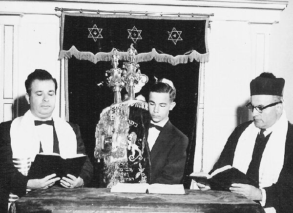 Vintage jewish boy bar mitzvah in a synagogues with two rabbis.